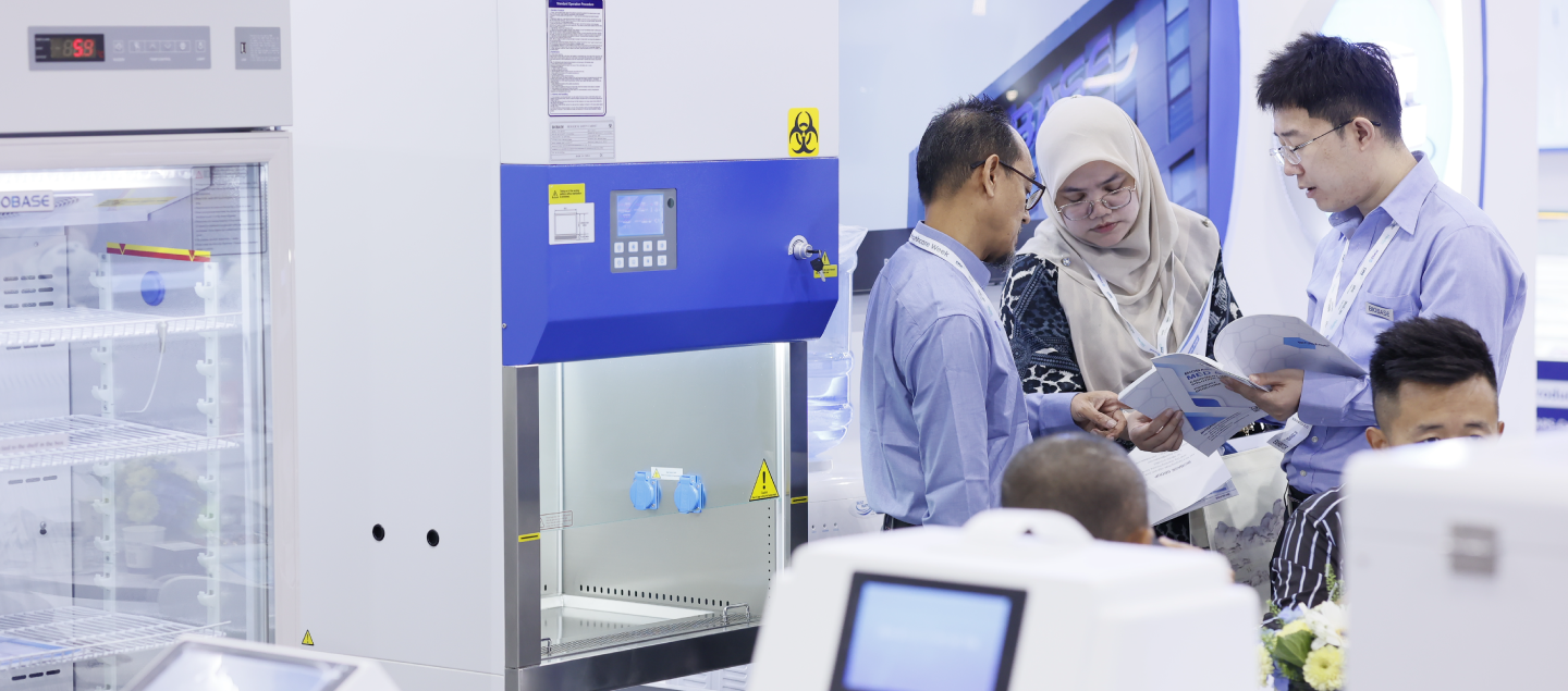 Exhibitor explaining a product to a potential customer at World Health Expo Bangkok