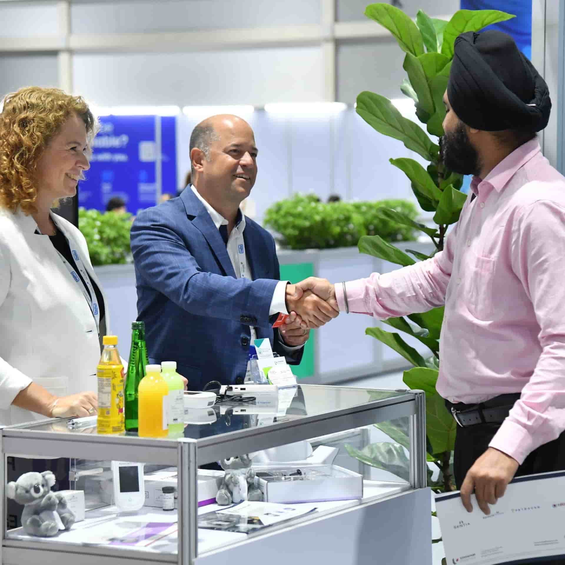  Exhibitor demonstrating a product to delegates at World Health Expo Kuala Lumpur