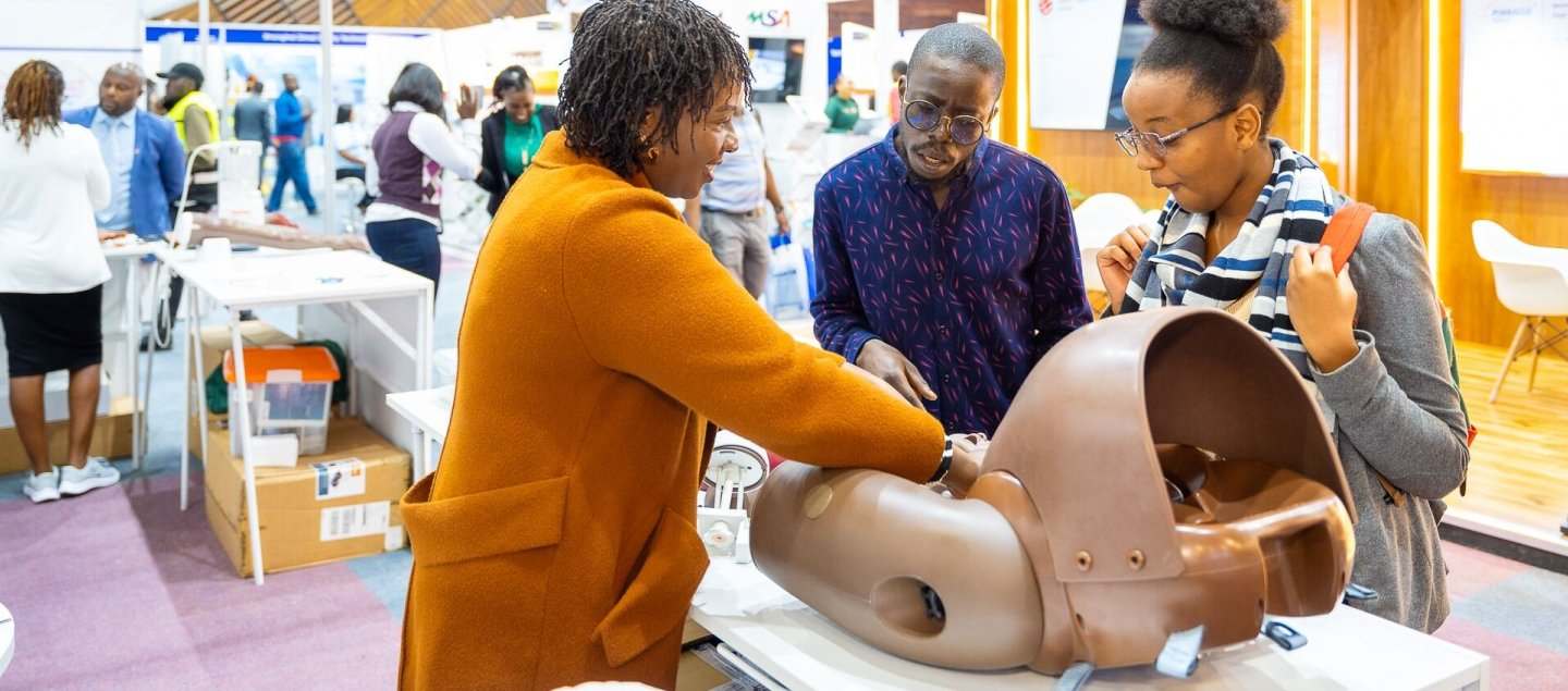 Exhibitor explaining a product to a potential customer at World Health Expo Nairobi
