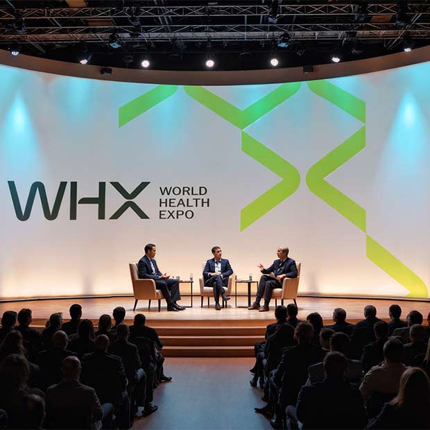 Speakers presenting on stage at a WHX event 