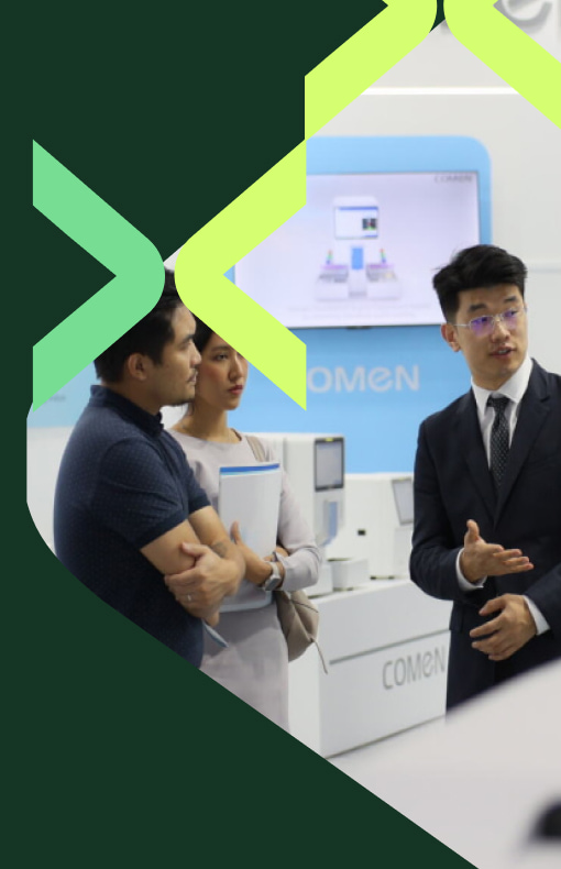 Exhibitor explaining a medical lab product at World Health Expo Labs Kuala Lumpur