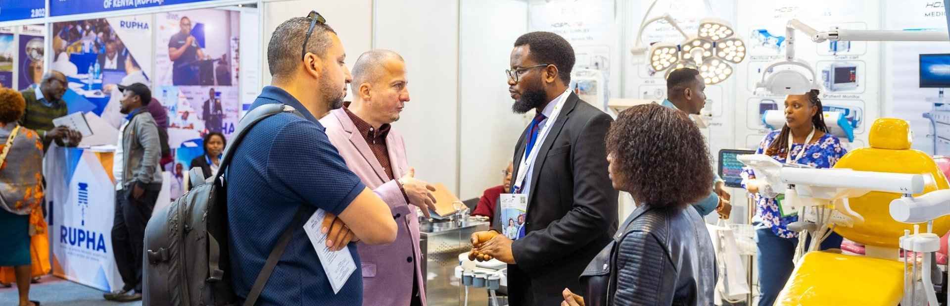 Conference attendees talking to an exhibitor at World Health Expo Labs Nairobi
