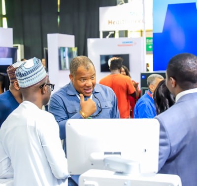 Exhibitor talking to attendees at WHX Lagos