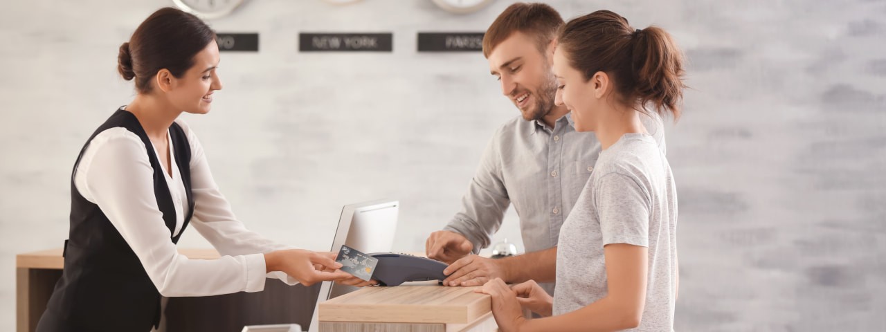 People checking in at a hotel