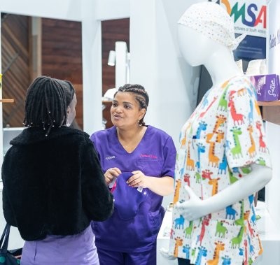 Attendee talking to an exhibitor at World Health Expo Nairobi
