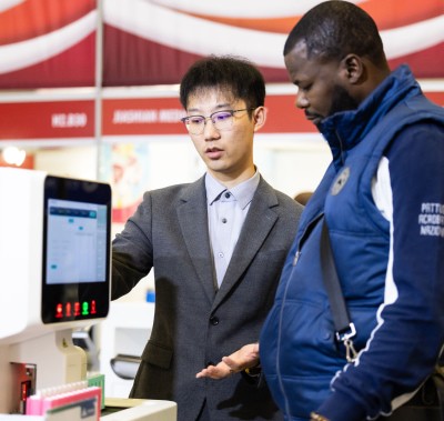 Exhibitor and attendee looking at a medical product at World Health Expo Labs Cape Town