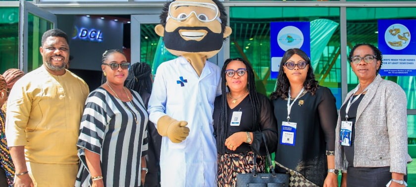 Delegates posing with Mr Medi, the event mascot, at the entrance to WHX Labs Lagos