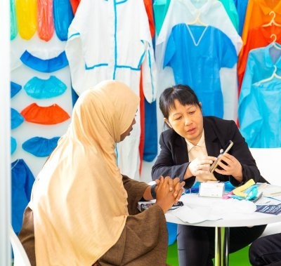 Exhibitor demonstrating a product to a potential customer at World Health Expo Labs Nairobi