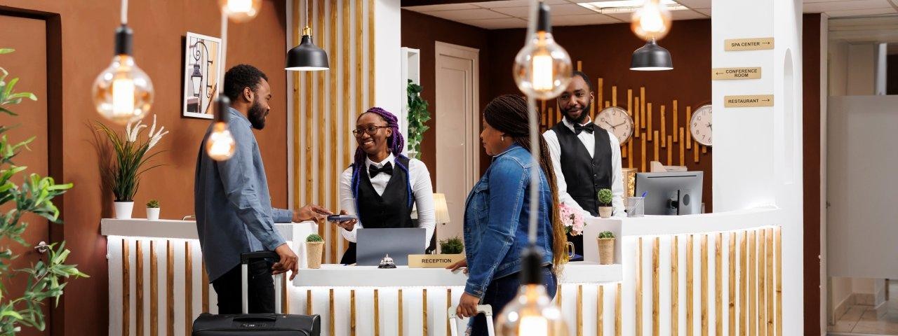 People checking in at a hotel reception